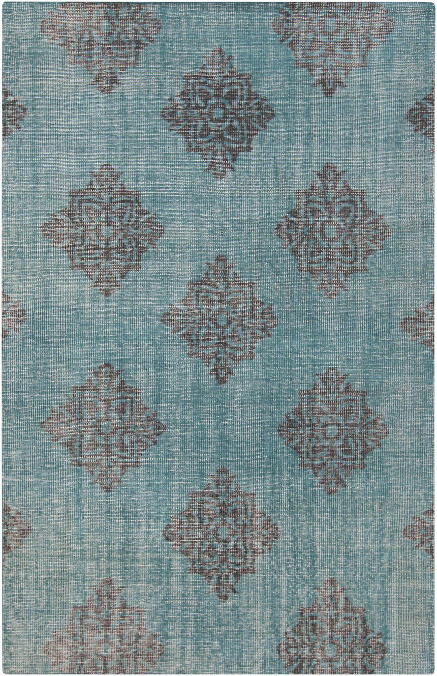 Close-up of the hand-knotted Presidio Area Carpet. Emerald background with black diamond medallion pattern. 100% wool texture. Design-Rectangle
