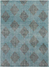 Close-up of the Presidio Area Carpet. Black floral medallions on an emerald, hand-knotted wool rug. Design-Rectangle