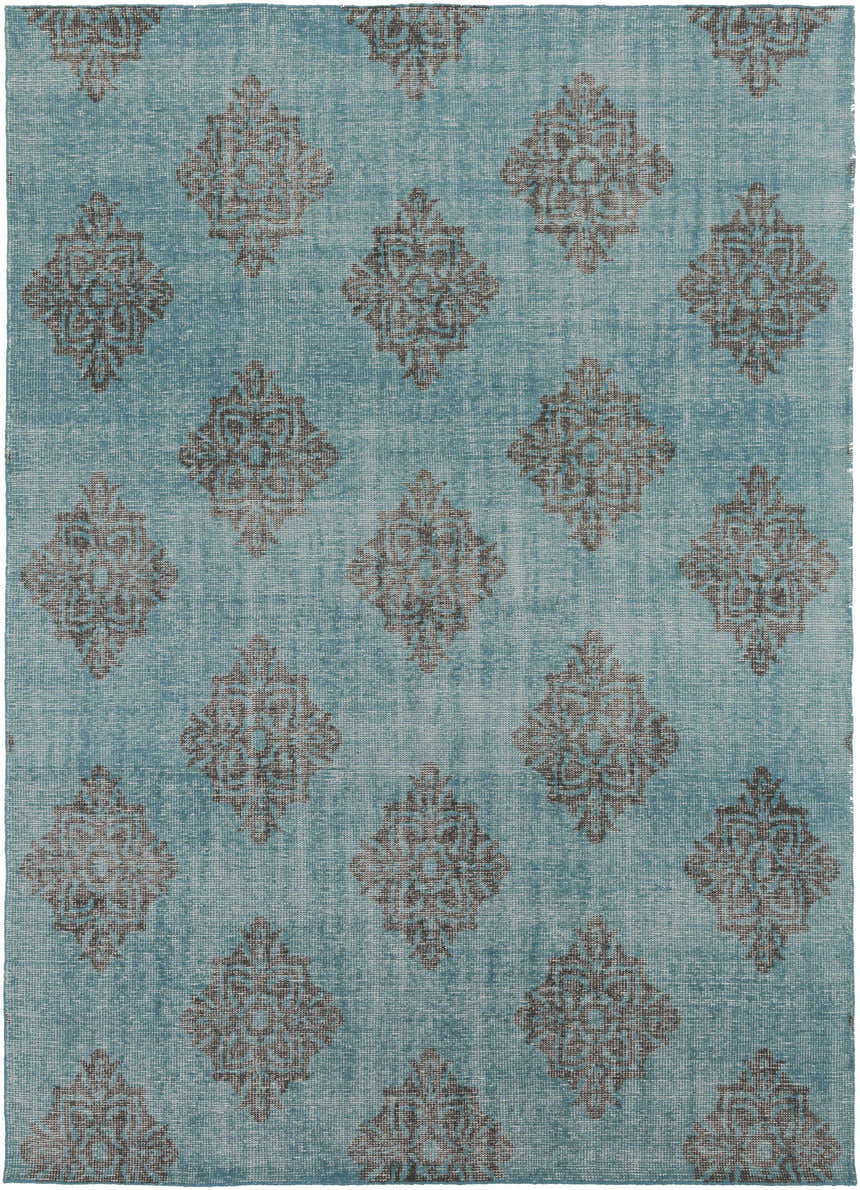 Close-up of the Presidio Area Carpet. Black floral medallions on an emerald, hand-knotted wool rug. Design-Rectangle