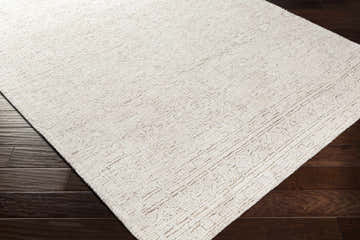 Close-up of the Probus Area Rug showing its textured weave and subtle geometric pattern in shades of white and brown. Corner