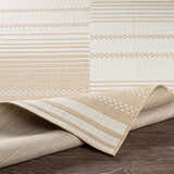 Close-up of the Portscatho Carpet, a beige and light beige rug with a contemporary striped and geometric pattern. Fold