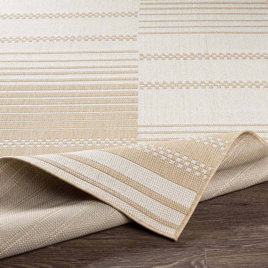Close-up of the Portscatho Carpet, a beige and light beige rug with a contemporary striped and geometric pattern. Fold