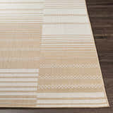 Close-up of the Portscatho Carpet. Beige and light beige rug with a striped and geometric pattern. Machine woven texture. Front