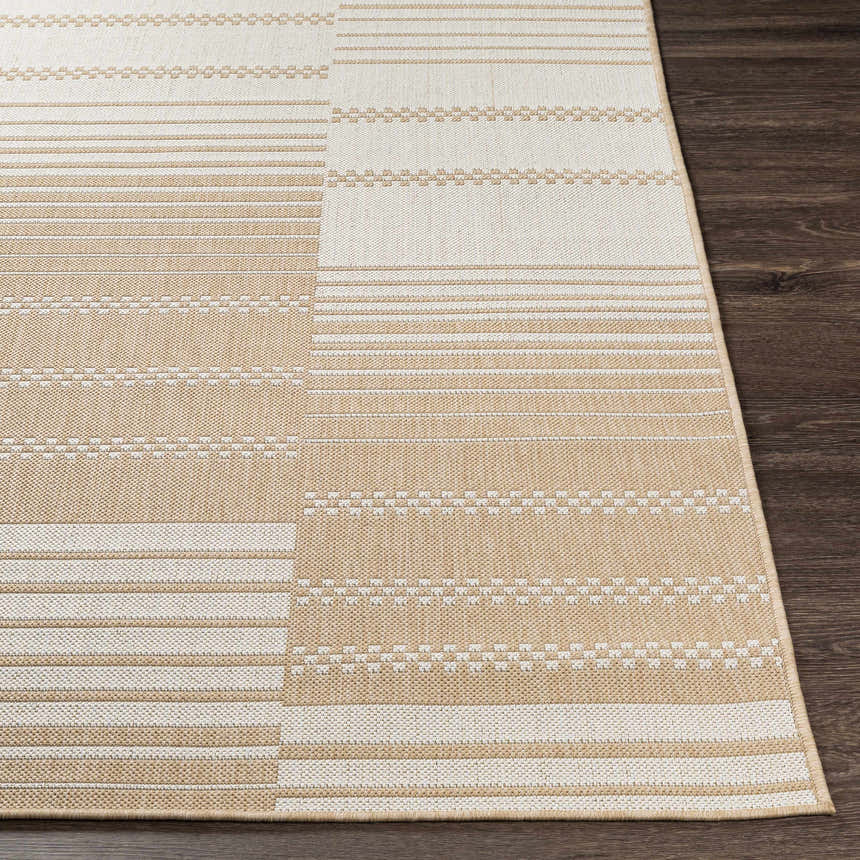 Close-up of the Portscatho Carpet. Beige and light beige rug with a striped and geometric pattern. Machine woven texture. Front