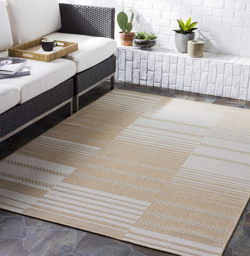 Beige Portscatho Carpet in a modern living room with a white sofa, brick wall, and potted plants. Roomscene-Rectangle