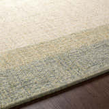 Close up of the hand tufted Pualas Area Rug. Cream, sage, and beige wool stripes add texture and color. Texture