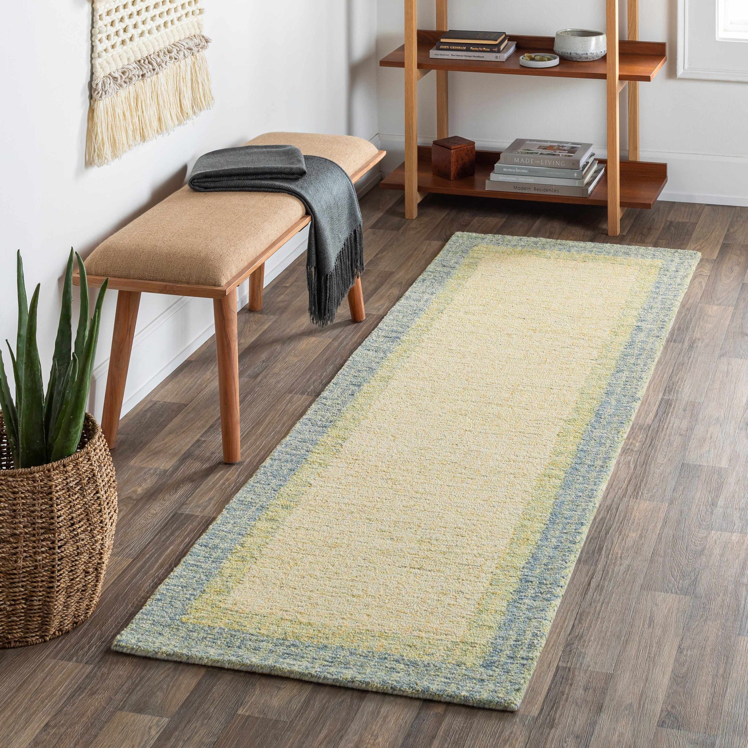 Entryway with a Pualas Area Rug runner in cream, sage, and light beige colors. Bench, shelf, and plant complete the scene. Roomscene-Runner