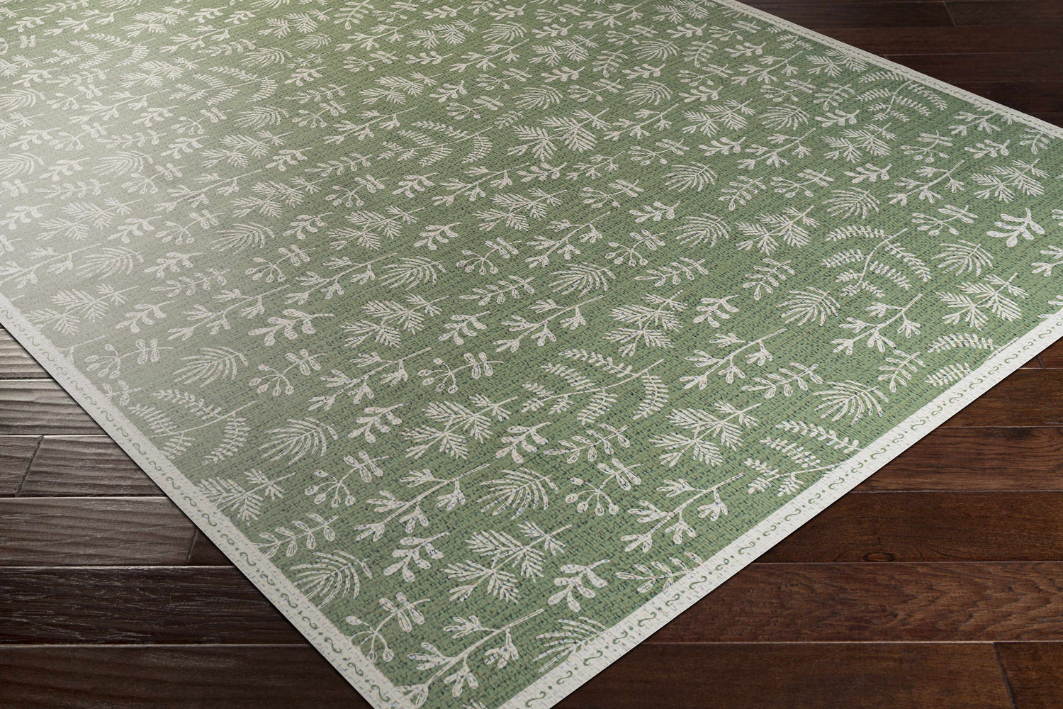 Close-up of the Pulteney Area Rug, a cream and olive vinyl rug with a contemporary botanical pattern. Corner