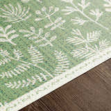 Close-up of Pulteney Area Rug; cream and olive vinyl with a contemporary floral pattern. Texture