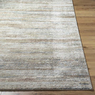 Close-up of the Agueda Thick Luxe Rug. Beige, tan, light gray, and olive hues with a soft, textured design. Front