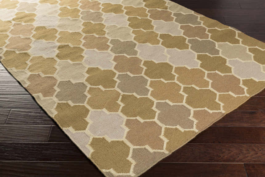 Close-up of the hand woven Quebeck Area Carpet. Features a contemporary quatrefoil pattern in cream, sage, gray, brown, and tan. Corner