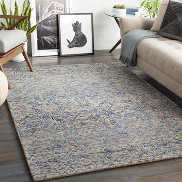 Living room scene with a blue and taupe Radisson Area Rug, beige sofa, and modern decor. Roomscene-Rectangle