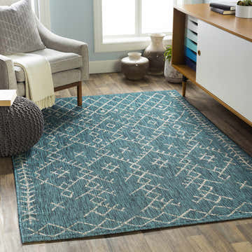 Living room scene with aqua Maunawili Nordic Rug, gray chair, ottoman, and modern cabinet. Bohemian style. Roomscene-Rectangle