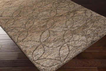 Close-up of the Roberts Area Carpet. Tan and dark brown jute and wool rug with a contemporary floral pattern. Corner