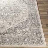 Close-up of the Rockfall Area Rug showing its charcoal, gray, and light beige traditional pattern and soft texture. Front