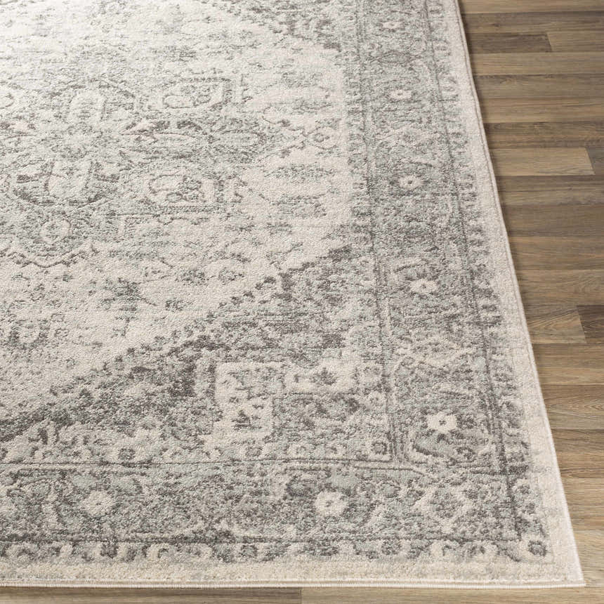 Close-up of the Rockfall Area Rug showing its charcoal, gray, and light beige traditional pattern and soft texture. Front