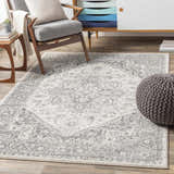 Living room scene with a gray Rockfall Area Rug, gray chair, and wood cabinet. Roomscene-Rectangle