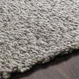 Close-up of the hand woven Rockfield Clearance Rug. Black and cream wool creates a textured, farmhouse style. Texture