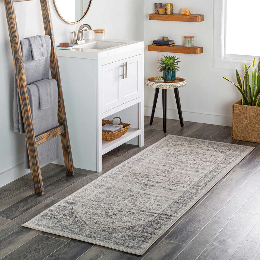 Bathroom scene with a gray Rockfall Area Rug, white vanity, wood accents, and plants. Roomscene-Runner