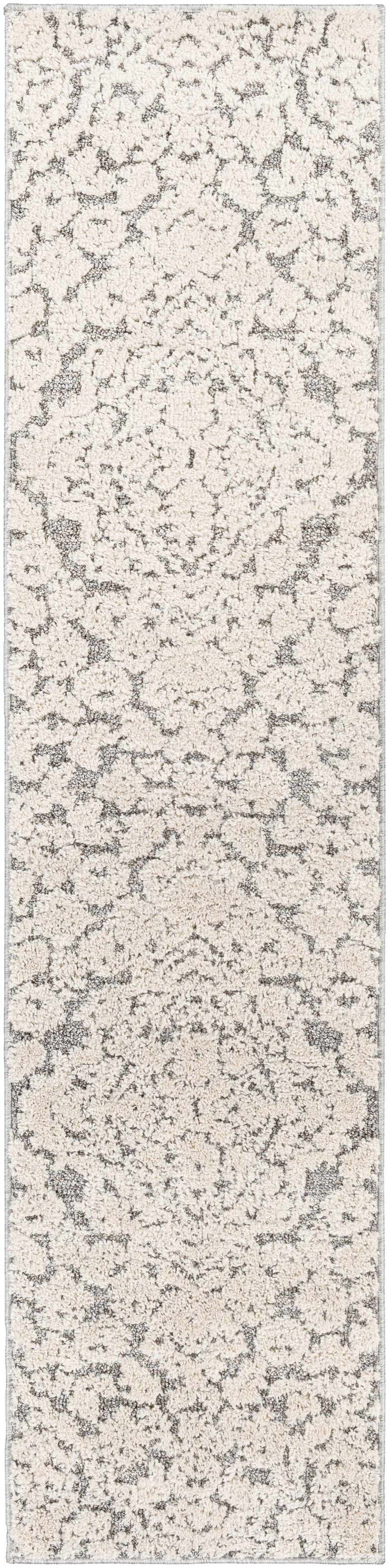 Close-up of the Rockeagle Area Rug's beige and charcoal abstract pattern. Machine-woven, 100% Polypropylene rug. Design-Runner