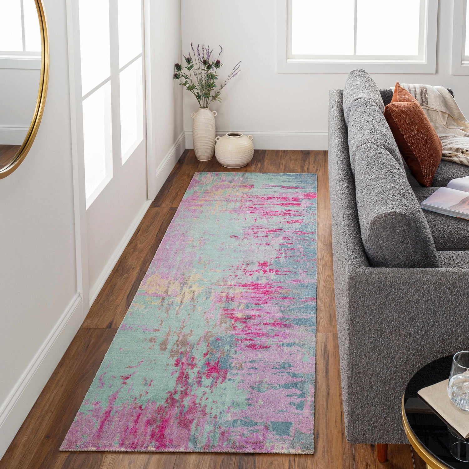 Living room scene with a gray sofa and the Redland Colorful Abstract Rug in aqua, pink, and lavender. Roomscene-Runner