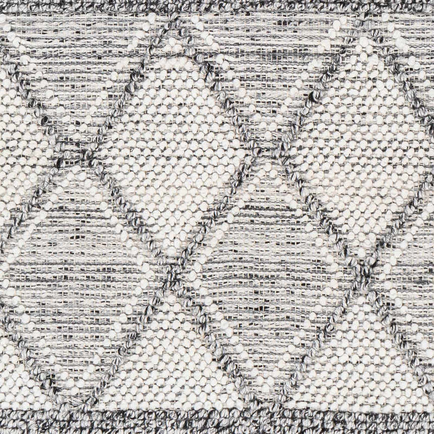 Close-up of the Rehn Area Rug, a hand-woven rug with a geometric pattern in dark gray, light gray, smoke, and taupe. Swatch