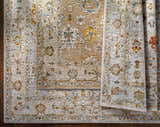 Close-up of Mogul Luxe Oushak Rug. Traditional floral pattern in brick red, cream, denim, mustard, olive, and tan. Styleshot