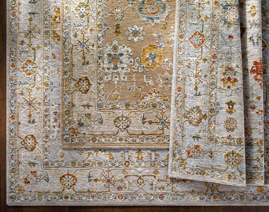 Close-up of Mogul Luxe Oushak Rug. Traditional floral pattern in brick red, cream, denim, mustard, olive, and tan. Styleshot