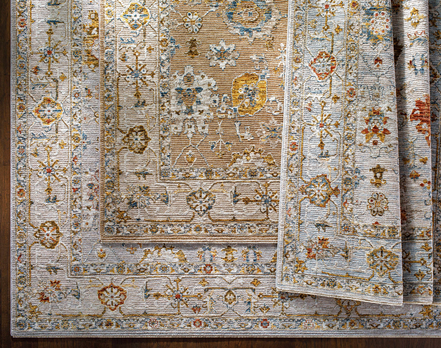 Close-up of Mogul Luxe Oushak Rug. Traditional floral pattern in brick red, cream, denim, mustard, olive, and tan. Styleshot