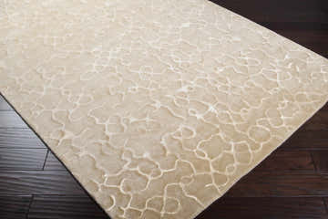 Close-up of a beige Renault Area Carpet showing its contemporary, hand-knotted design and subtle geometric pattern. Corner