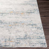 Close-up of Rendlesham Luxe Rug in cream, dusty sage, gray, mustard, and teal on dark wood floor. Contemporary style. Front