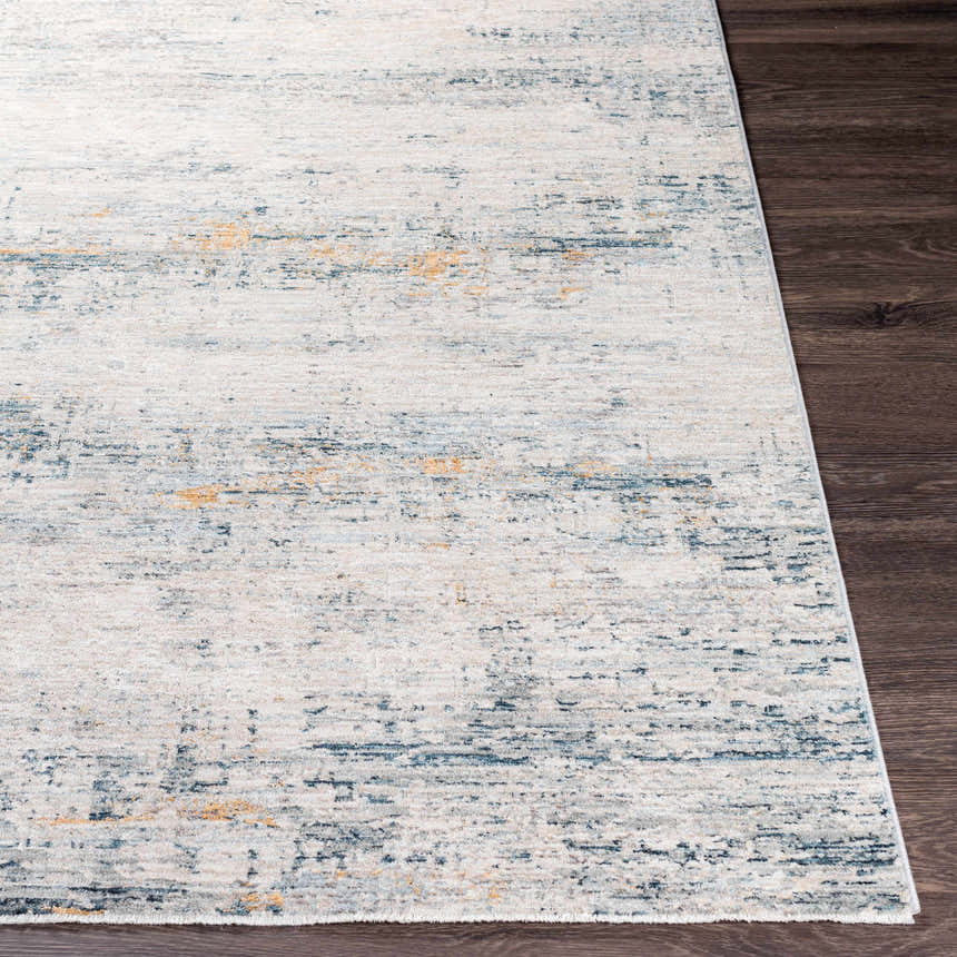 Close-up of Rendlesham Luxe Rug in cream, dusty sage, gray, mustard, and teal on dark wood floor. Contemporary style. Front