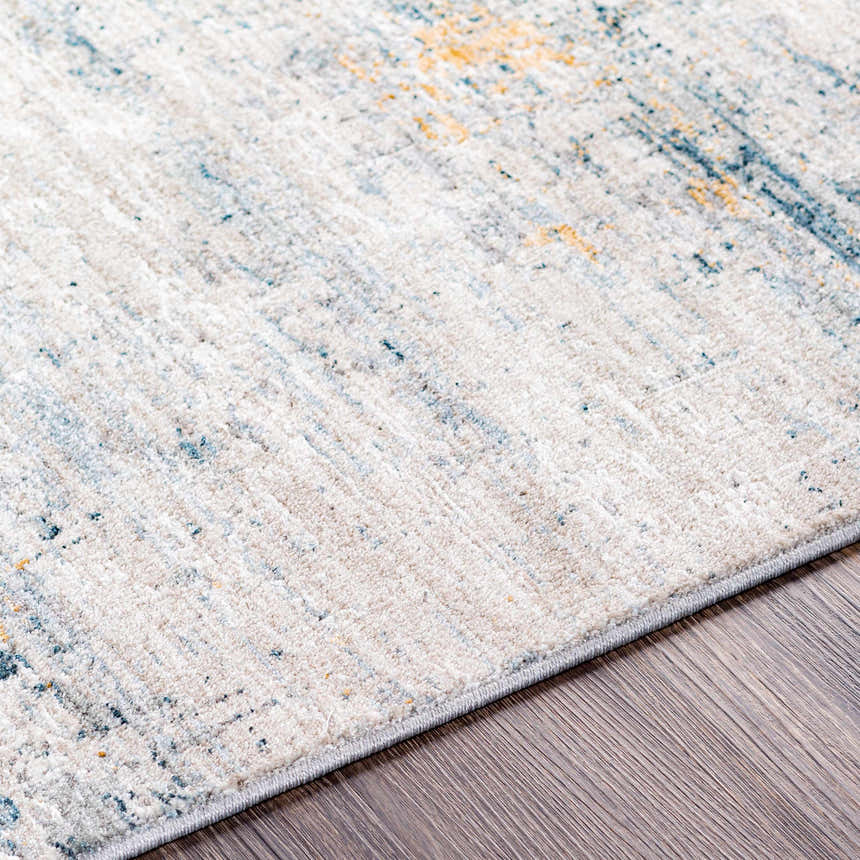 Close-up of the Rendlesham Luxe Rug showing cream, teal, and mustard colors with a contemporary abstract pattern. Texture