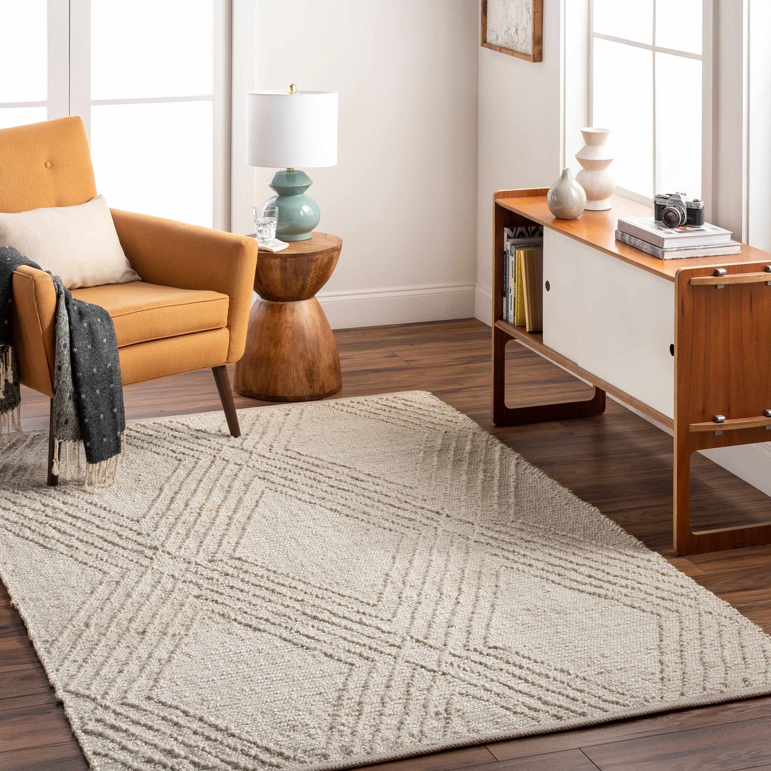 Living room scene with a beige Renz Area Rug, mustard chair, and mid-century modern console. Roomscene-Rectangle