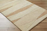 Close-up of the Robin Modern Wool Rug; caramel and cream geometric design, hand-tufted texture. Corner