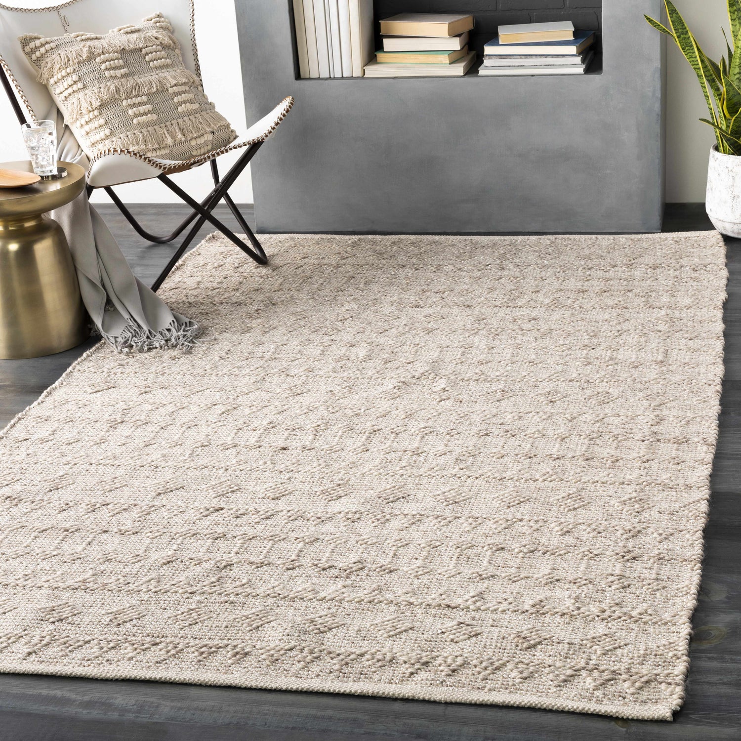 Scandinavian-style room with a metallic silver Argonne Area Rug, white chair, and gold side table. Roomscene-Rectangle