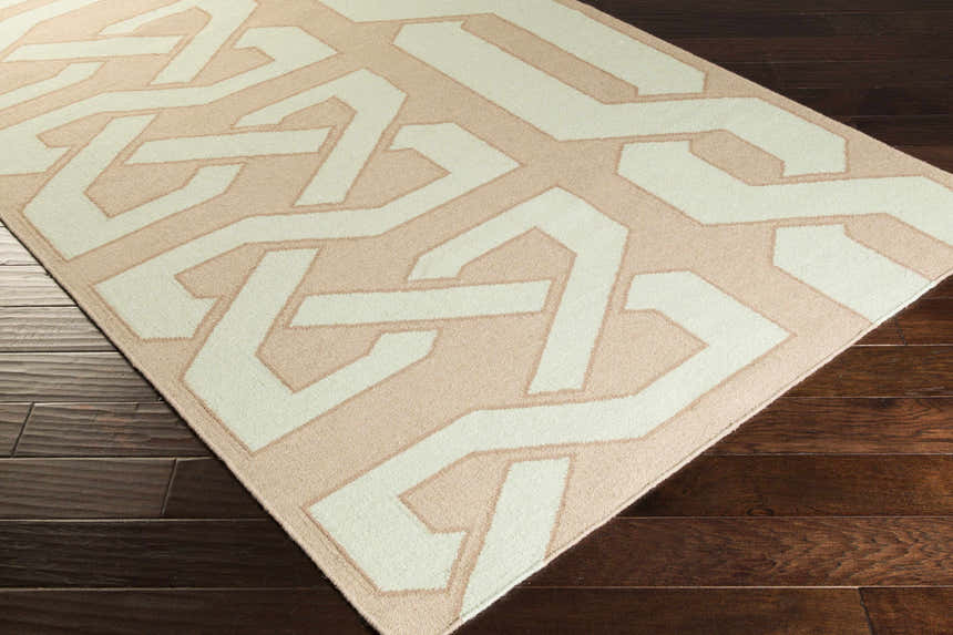 Close-up of the Rhodell Area Rug, a hand-woven wool rug with a geometric pattern in gray, light beige, and seafoam. Corner