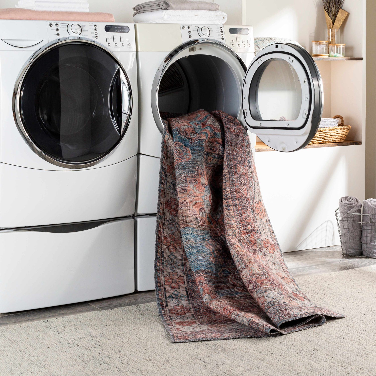 Laundry room scene with Baltinglass Rust & Blue Washable Area Rug coming out of the dryer. Easy to clean rugs. Washing-Machine