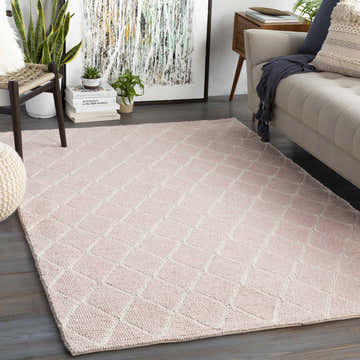 Living room scene with a Riceville Pink Trellis Wool & Viscose Rug, beige sofa, wood chair, and modern art. Roomscene-Rectangle
