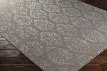 Close-up of the Riddle Carpet in medium gray and tan, featuring a contemporary floral damask pattern. Corner