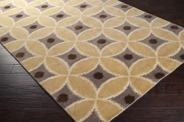 Close up of the Rindge Area Carpet, a wool rug with brown, ivory, and mustard circle pattern. Corner