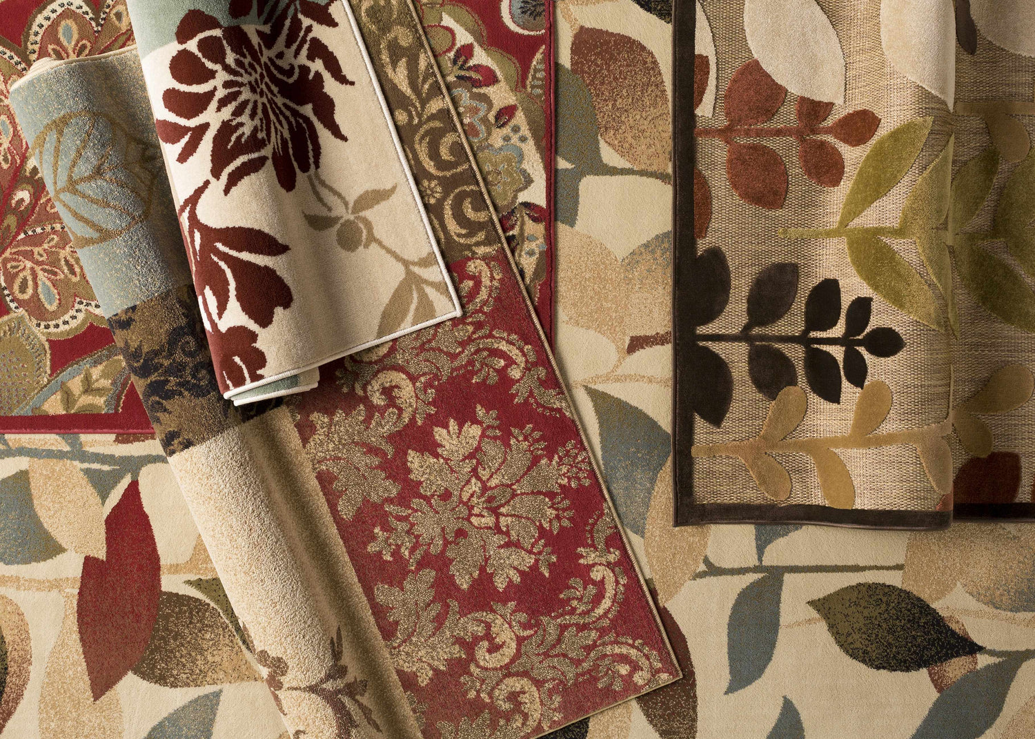 Close-up of Ober Fall Leaves Rug showing floral and leaf patterns in black, red, brown, green, and beige. Styleshot