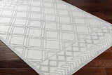 Close-up of the Rena Area Rug in arctic stone and gray, featuring a geometric diamond pattern and hand-woven texture. Corner