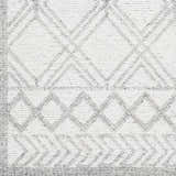 Close-up of the Rena Area Rug, showcasing its hand-woven texture and geometric diamond pattern in arctic stone and gray tones. Swatch