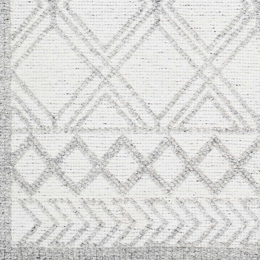 Close-up of the Rena Area Rug, showcasing its hand-woven texture and geometric diamond pattern in arctic stone and gray tones. Swatch