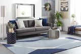Living room scene with gray sofa and blue Robbins Modern Blue Wool Rug featuring geometric pattern. Roomscene-Rectangle