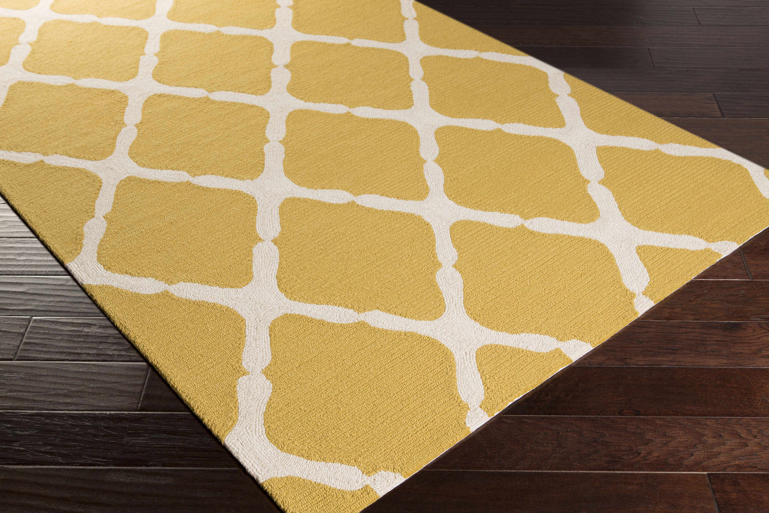 Close-up of the Roper Area Rug, a hand-hooked rug in mustard and light gray with a contemporary geometric pattern. Corner