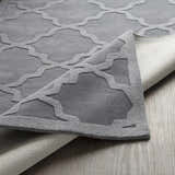 Close up of the gray Ropesville Wool Area Rug showing the geometric trellis pattern and hand loomed texture. Fold