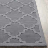 Close-up of the gray Ropesville Wool Area Rug showing its hand-loomed texture and contemporary trellis pattern. Front