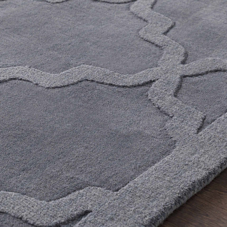 Close-up of the gray Ropesville Wool Area Rug, featuring a textured geometric pattern and hand-loomed construction. Texture